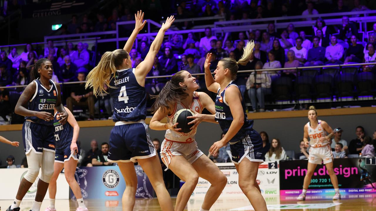 GEELONG, AUSTRALIA - OCTOBER 30: Alicia Froling of the Townsville Fire drives to the basket against Jazmin Shelley of Geelong United and Elissa Brett of Geelong United during the round one WNBL match between Geelong United and Townsville Fire at The Geelong Arena, on October 30, 2024, in Geelong, Australia. (Photo by Kelly Defina/Getty Images)