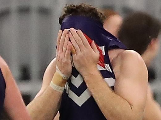 PERTH, AUSTRALIA - AUGUST 15: Reece Conca of the Dockers reacts as the Blues celebrate winning the round 12 AFL match between the Fremantle Dockers and the Carlton Blues at Optus Stadium on August 15, 2020 in Perth, Australia. (Photo by Paul Kane/Getty Images)