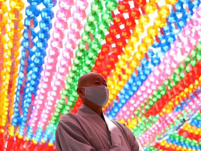 A Buddhist monk wears a mask as he attends a ceremony of Buddha’s birthday at Jogyesa Temple in Seoul, South Korea on the weekend. Picture: Getty Images