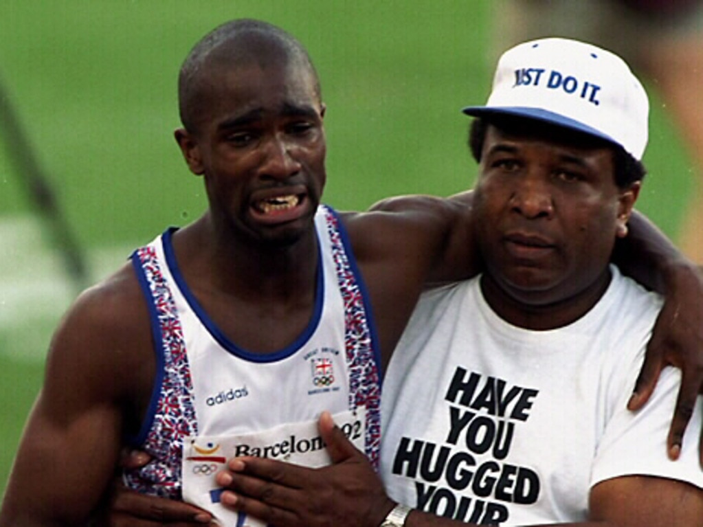 Britain’s athlete Derek Redmond is helped from track by his father after falling during semi-finals of men's 400 at 1992 Olympic Games.