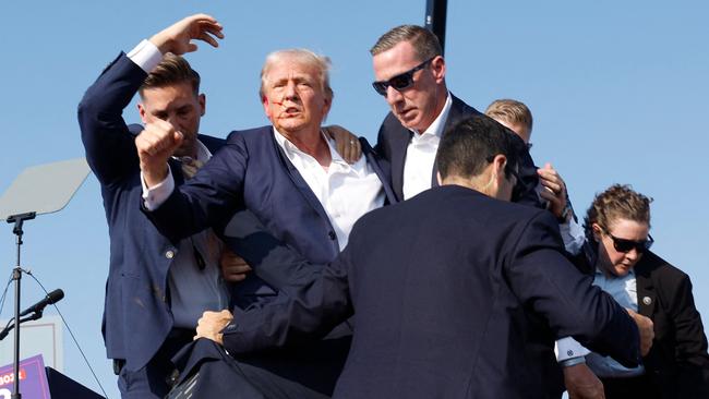 Donald Trump gestures to supporters as he is rushed offstage in Butler, Pennsylvania. Picture: Getty Images