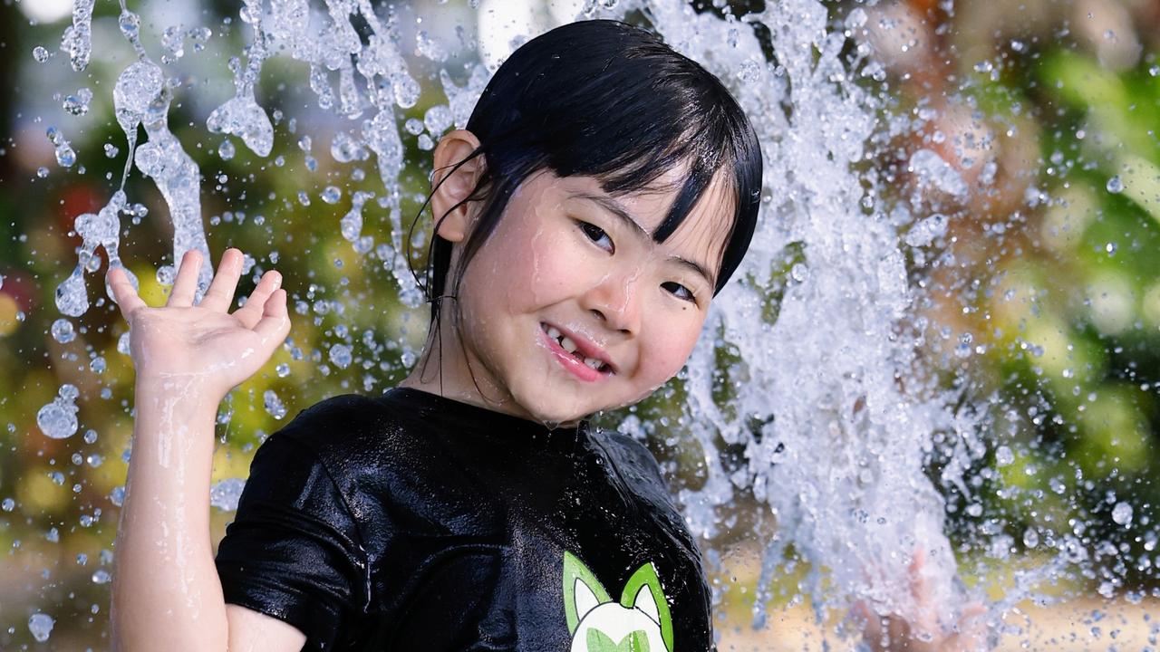 Serena Hamada, 6, keeping cool in the fountains at Muddy’s Playground, Cairns. Picture: Brendan Radke