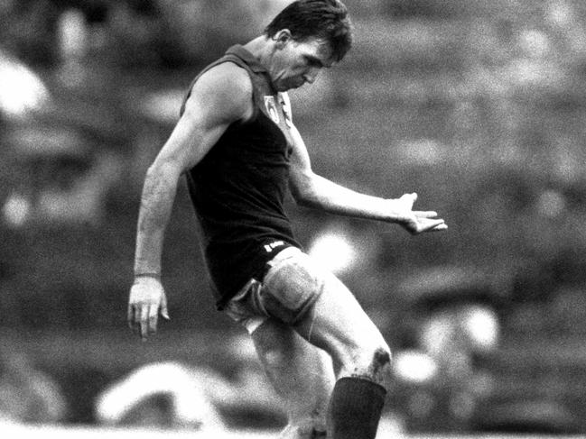 Jim Stynes gets a kick away.