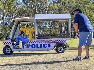 Colleen Smith watches on as Tony Noyes takes a shot at the Andersons Auto City Gladstone Police Charity Golf Day held at Gladstone Golf Club on 9 August 2019. Picture: Matt Taylor GLA090819GOLF