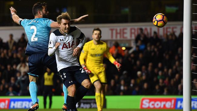 Tottenham Hotspur's Danish midfielder Christian Eriksen heads the ball to score.