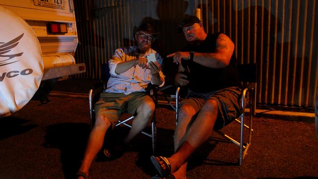 KI residents and brothers Jan and BJ Boers at the Kingscote Jetty in the early hours of Friday, after bushfires flared out of control during the night. Picture: Lisa Maree Williams/Getty