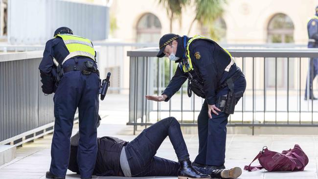 Police detain two men who interrupted Premier Daniel Andrews’ Covid press conference today. Picture: NCA NewsWire / Wayne Taylor