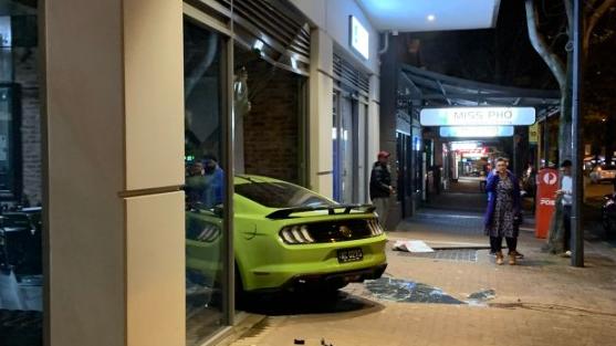 The Mustang embedded in the Norwood Parade barber shop. Picture: @KellyCHughes_/9 News Adelaide