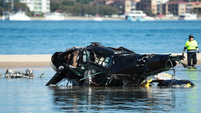 Queensland Police and ATSB Officers recover the wreckage after four people were killed and others injured when two helicopters collided near Sea World on the Gold Coast. Picture: Scott Powick