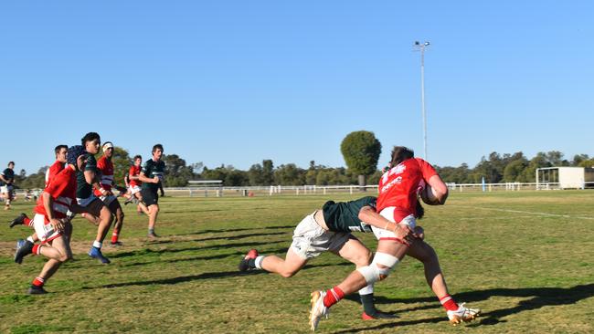 Spectators cheer on as they watch the B Grade St George vs Condamine match at the Roma Rugby Races at Bassett Park. Picture: Chloe Cufflin.