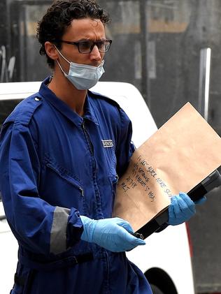 A Nike slide found at the entrance of the building is bagged as evidence. Picture: Nicole Garmston.