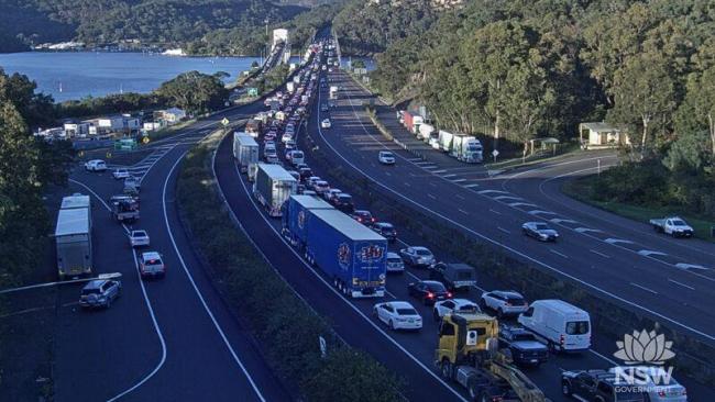 A truck driver has become trapped after a horror crash involving at least 10 vehicles on Peats Ferry Bridge on NSW’s M1 Pacific Motorway, bringing peak-hour traffic to a standstill. Picture: Libe Traffic NSW.
