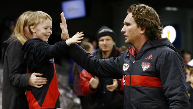 James Hird high fives a young Essendon fan during his coaching tenure. Picture: Michael Klein