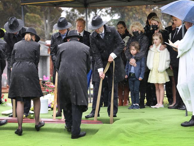 Bert Newton is lowered to his final rest at Springvale Cemetery. Picture: David Caird