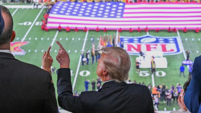 Donald Trump takes in the Super Bowl pre-game show at Caesars Superdome in New Orleans on Monday AEDT. Picture: AFP