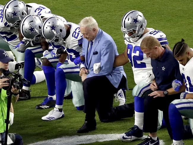 The Dallas Cowboys, led by owner Jerry Jones, center, take a knee prior to the national anthem prior to an NFL football game against the Arizona Cardinals, Monday, Sept. 25, 2017, in Glendale, Ariz. (AP Photo/Matt York)