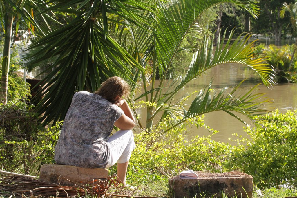 A disabled woman and resident of the Wallace Caravan Park and Motel watches as the Mary River slowly floods her home. Photo: Robyne Cuerel / Fraser Coast Chronicle. Picture: Robyne Cuerel