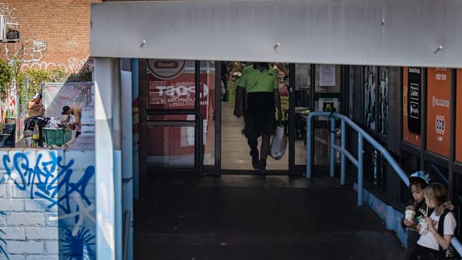 Two drug users just metres from young children outside the St Kilda supermarket. Picture: Jason Edwards