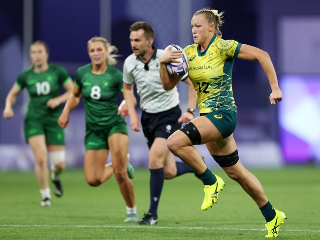 Maddison Levi breaks clear to score Australia's third try. Picture: Getty Images