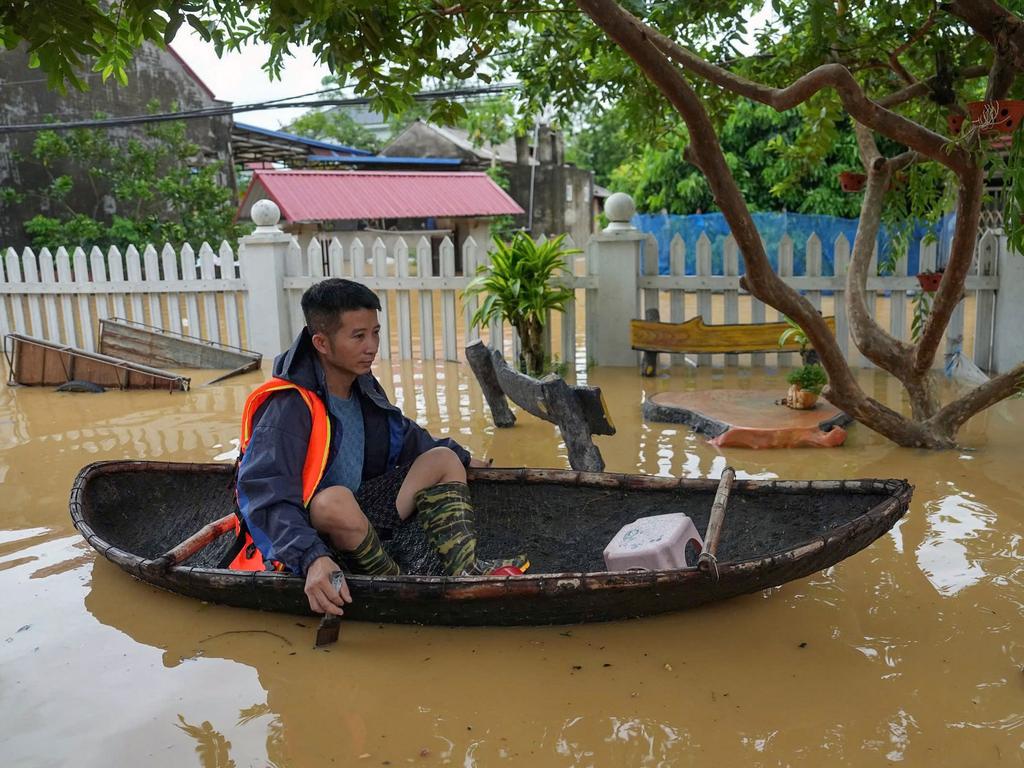 A man rows a boat through flood waters in Thai Nguyen province on September 10, in the aftermath of Typhoon Yagi hitting northern Vietnam. Picture: Huu Hao / AFP