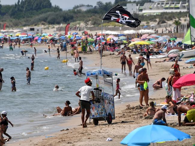 People enjoy the beach in La Grande-Motte on August 1, 2018 as a heatwave is sweeping across northern Europe. Picture: Pascal Guyot
