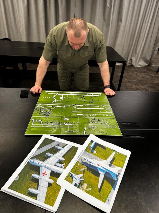 The head of Ukraine’s Security Service Vasyl Malyuk looks at a map showing a Russian military aircraft base. Picture: AFP