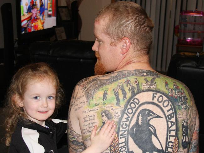 Tasmania's own Mr Collingwood, Peter Knowles of Legana, has the history of AFL club Collingwood tattooed on his back, at home with his daughter Hayley (4) where they will watch the 2010 AFL grand final game