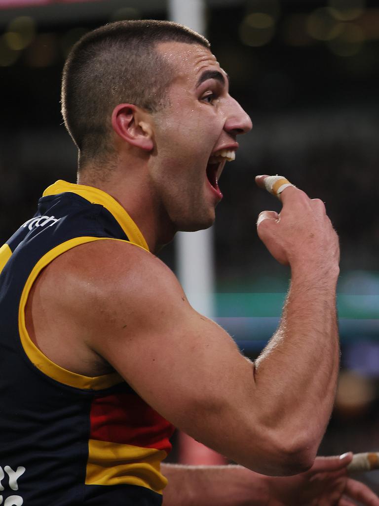 Josh Rachele of the Crows gestures to Port fans after scoring a goal at Adelaide Oval. Picture: James Elsby/AFL Photos via Getty Images