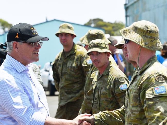 Prime Minister Scott Morrison is seen greeting troops during a visit to an army water purification station at Kingscote Jetty on Kangaroo Island. Picture: AAP