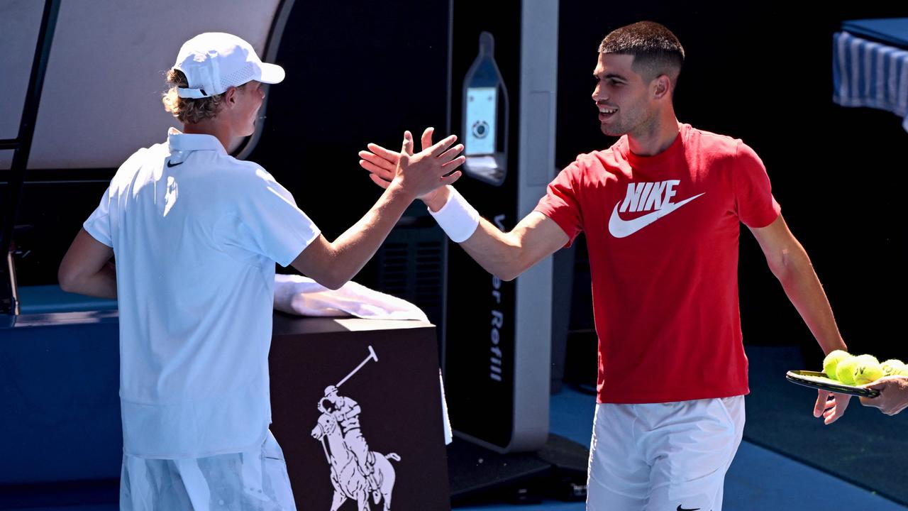 Carlos Alcaraz of Spain shakes hands with hitting partner Cruz Hewitt. Photo by William WEST / AFP.