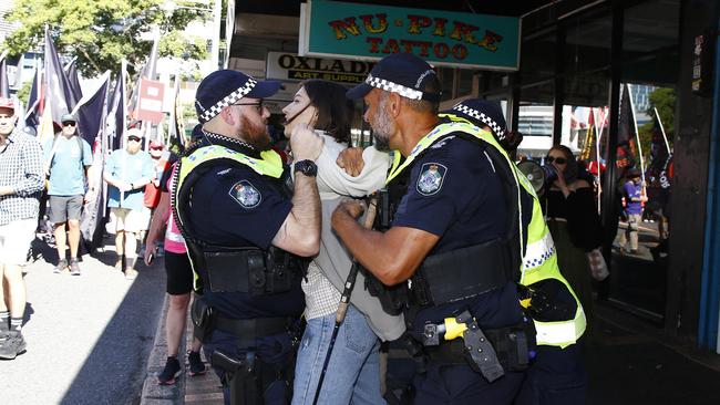 The protester was restrained by four police officers. Picture: NCA NewsWire/Tertius Pickard