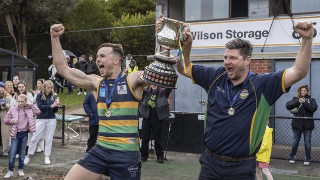 St Kevin’s captain Sam Critchley and coach Anthony Lynch lift the premiership trophy. Picture: Valeriu Campan