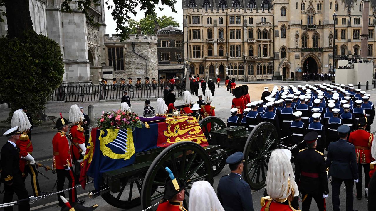 The coffin of Queen Elizabeth II, draped in the Royal Standard, arrives at Westminster Abbey in London.