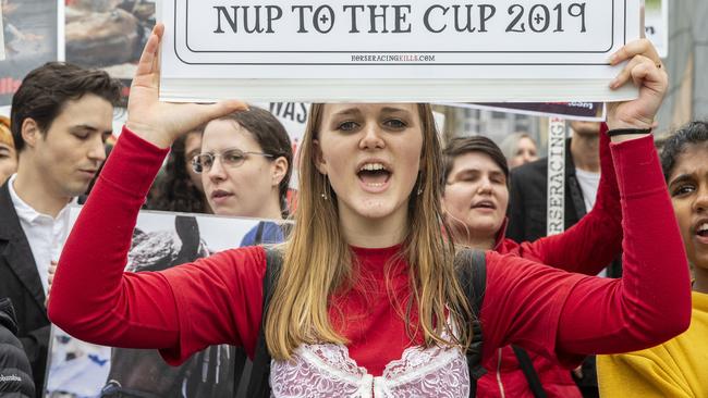 An anti horse racing protester holds up a banner and chants in Federation Square during the 2019 Melbourne Cup Parade on Monday.