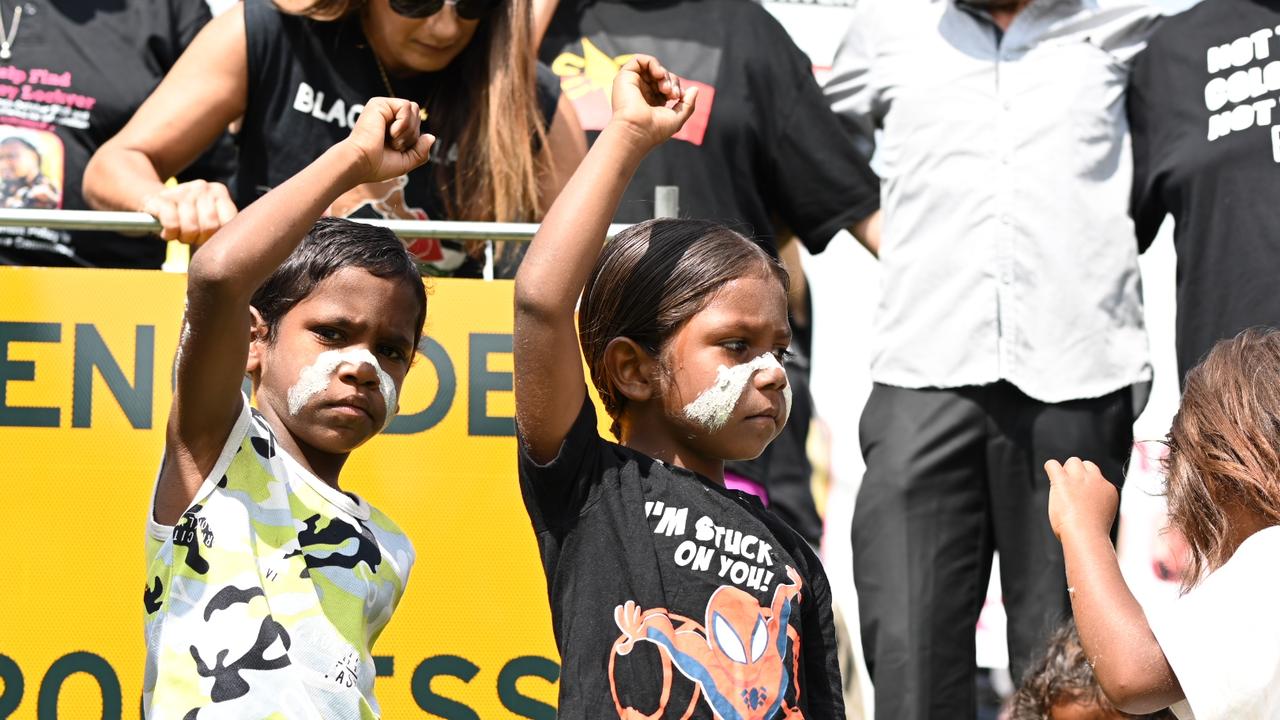 Children posed in front of a sign that read ‘Genocide in progress’ displayed by Senator Thorpe. Picture: NewsWire/ Martin Ollman