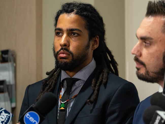 Former AFL player Joel Wilkinson (left) during a press conference at the Shine Lawyers office in Melbourne, Thursday, May 10, 2018. Wilkinson spoke about his case against the AFL, claiming he suffered years of racial abuse and sexual harassment during his playing career. (AAP Image/Andrew Leeson) NO ARCHIVING