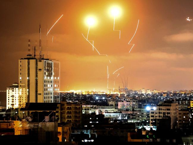 TOPSHOT - Rockets fired towards Israel from Gaza City, controlled by the Palestinian Islamist movement Hamas, are intercepted by Israel's Iron Dome Aerial Defence System on May 10, 2021. (Photo by MAHMUD HAMS / AFP)