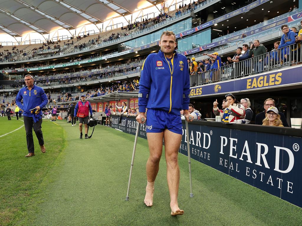 Matt Flynn of the Eagles leave the field on crutches after the team’s defeat after his side’s loss to Hawthorn. Picture: Will Russell/AFL Photos via Getty Images)