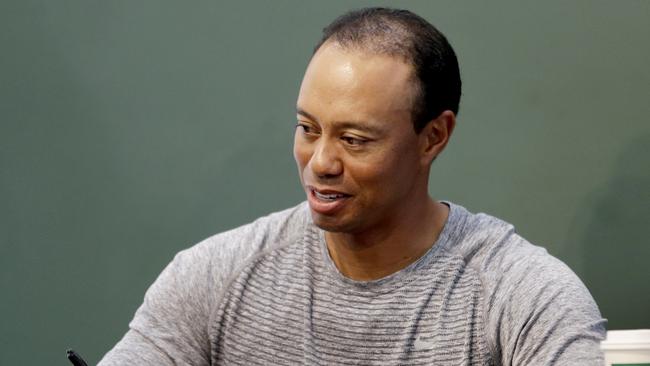Golfer Tiger Woods signs copies of his new book in New York.