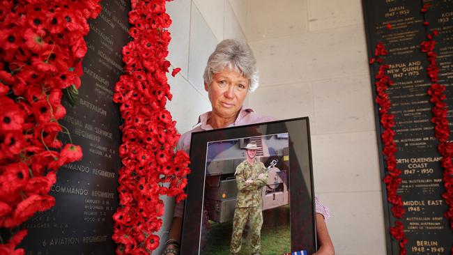 Janny Poate at the Australian War Memorial in Canberra with a photo of her son Robert Poate and his medals. Picture: Gary Ramage