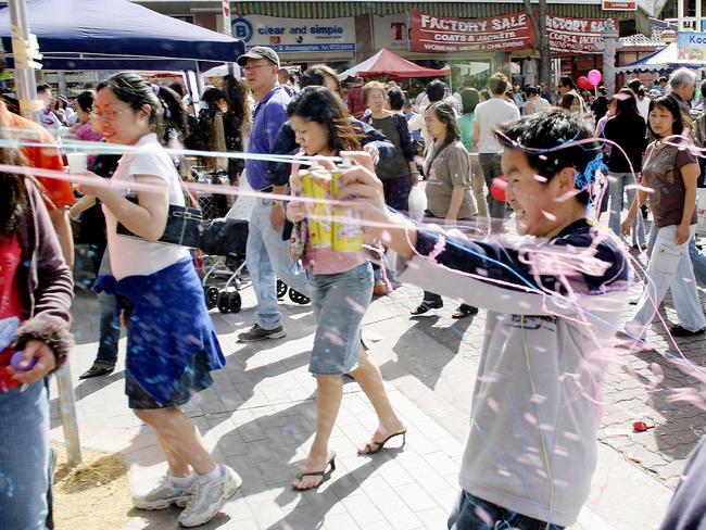 Kids spray each other with crazy string at the Cabramatta moon festival in 2005. Picture: James Horan