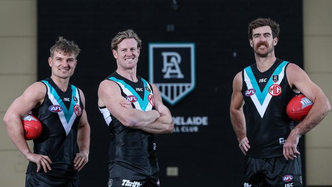 Ollie Wines, left, and Port Adelaide captain Tom Jonas, centre, and are set to play their 150th games while Scott Lycett will play his 100th. Picture: Sarah Reed