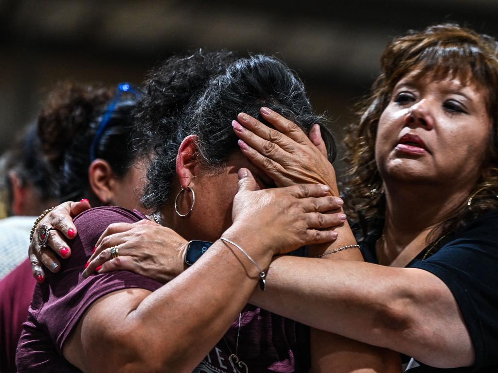 A woman cries as she attends the vigil for the victims of the mass shooting.