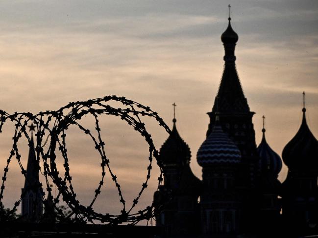 (FILES) This photograph shows a view of the Kremlin taken on May 17, 2023 through the barbed wire of a municipal technical facility in Moscow. Stubborn inflation, exorbitant borrowing costs, bankruptcy risks and a growth slowdown: the Russian economy is facing a slew of negative headlines, as the costs of the Ukraine war and Western sanctions mount. (Photo by Alexander NEMENOV / AFP)