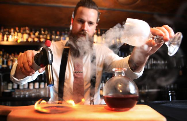 Barman Tom Loosli making the Smoky Rob cockatil at Eau de Vie. Picture: Bob Barker