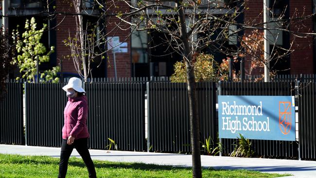 A person walks past an empty Richmond High School during September’s lockdown. Picture: NCA NewsWire / Andrew Henshaw