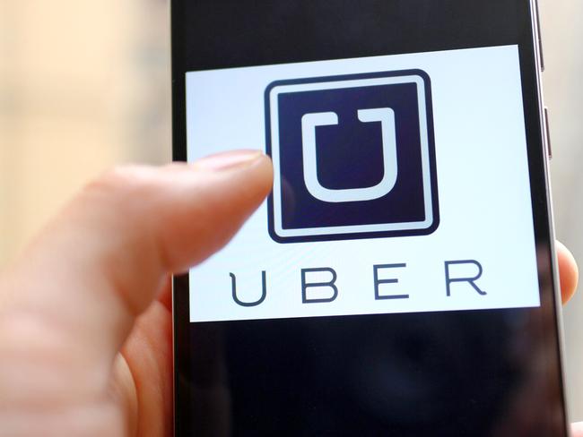 --FILE--A mobile phone user shows the logo of car-hailing app Uber on his smartphone in Chengdu city, southwest China's Sichuan province, 6 May 2015. U.S. firm Uber Technologies Inc and Chinese rival Didi Kuaidi are taking steps to operate legally in China, a key market for both firms but where their car hailing services currently operate in a regulatory prey zone. Uber China said in a statement on Thursday (8 October 2015) it was "actively preparing" documents to apply for a license to operate an online car-hailing platform to meet new regulations governing the sector that are expected to be announced soon. Didi Kuaidi, a $16 billion valued firm backed by Chinese Internet giants Alibaba Group Holding Ltd and Tencent Holdings Ltd, also said on Thursday it had received a car booking license for its operations in Shanghai and that it was seeking more licenses from other cities.