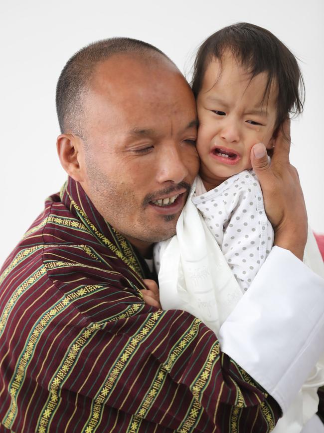 Father Sonam Tshering holds Nima. Picture: Alex Coppel