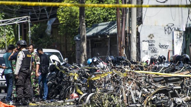 Police and soldiers examine a site following attacks outside the Surabaya Centre Pentecostal Church in East Java.