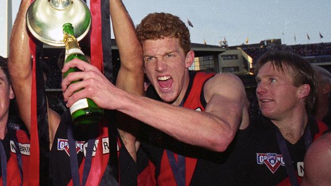 26/09/1993. 1993 Grand Final. Essendon v Carlton. MCG. Sean Denham, Joe Misiti and Dustin Fletcher with premiership cup. Champagne.